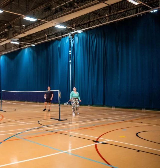 Sports hall at GL1 Leisure Centre, set up for badminton