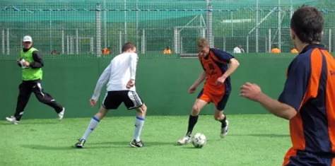 Adults playing 5-a-side in an enclosed pitch at the Glen Resource and Sports Centre