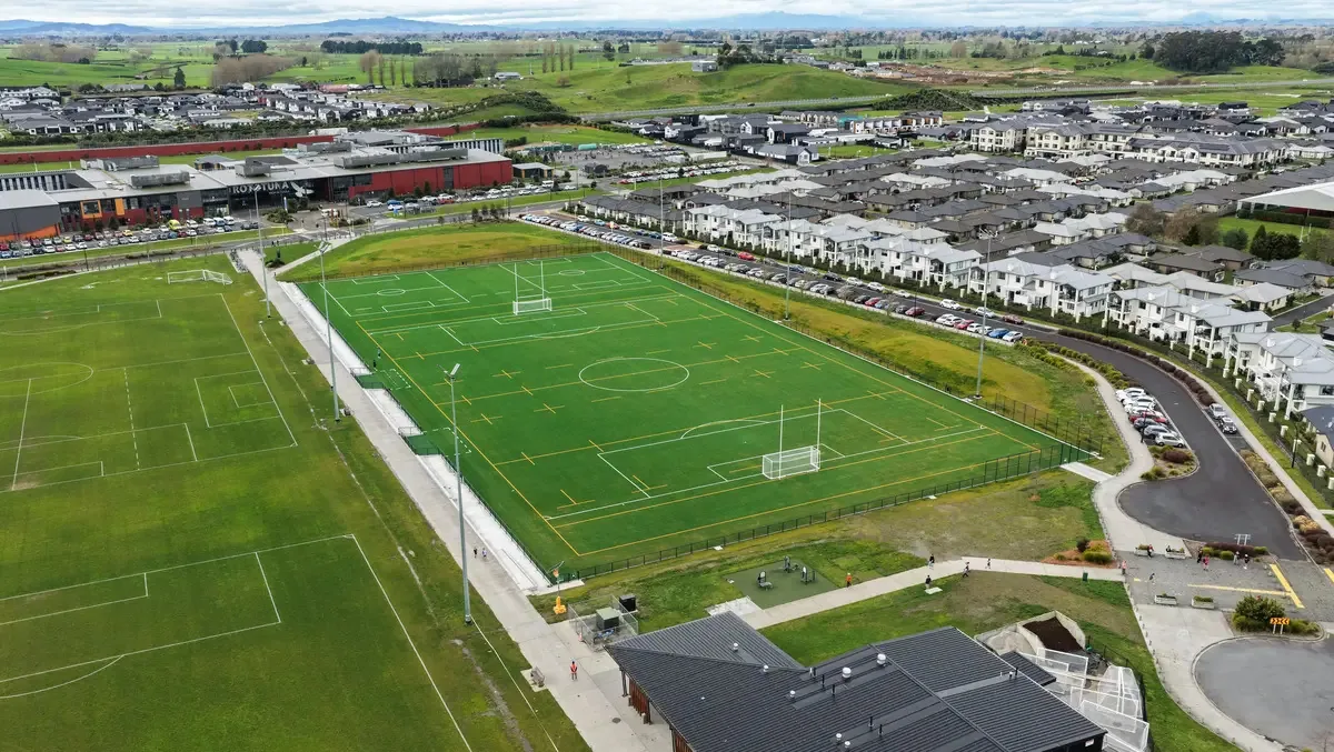 Aerial view of the floodlit artificial turf and grass fields at Korikori Park, Rototuna
