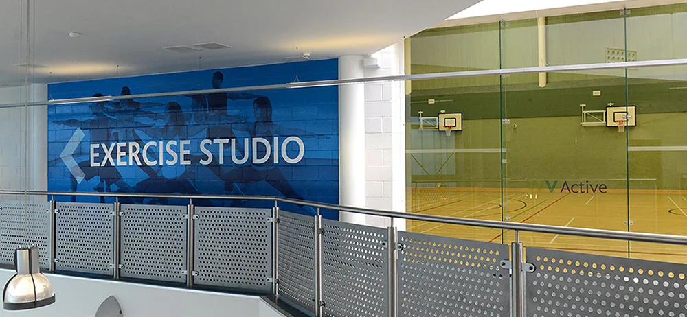 Sports hall at WV Active Bilston-Bert Williams, seen through the glass from the studio landing